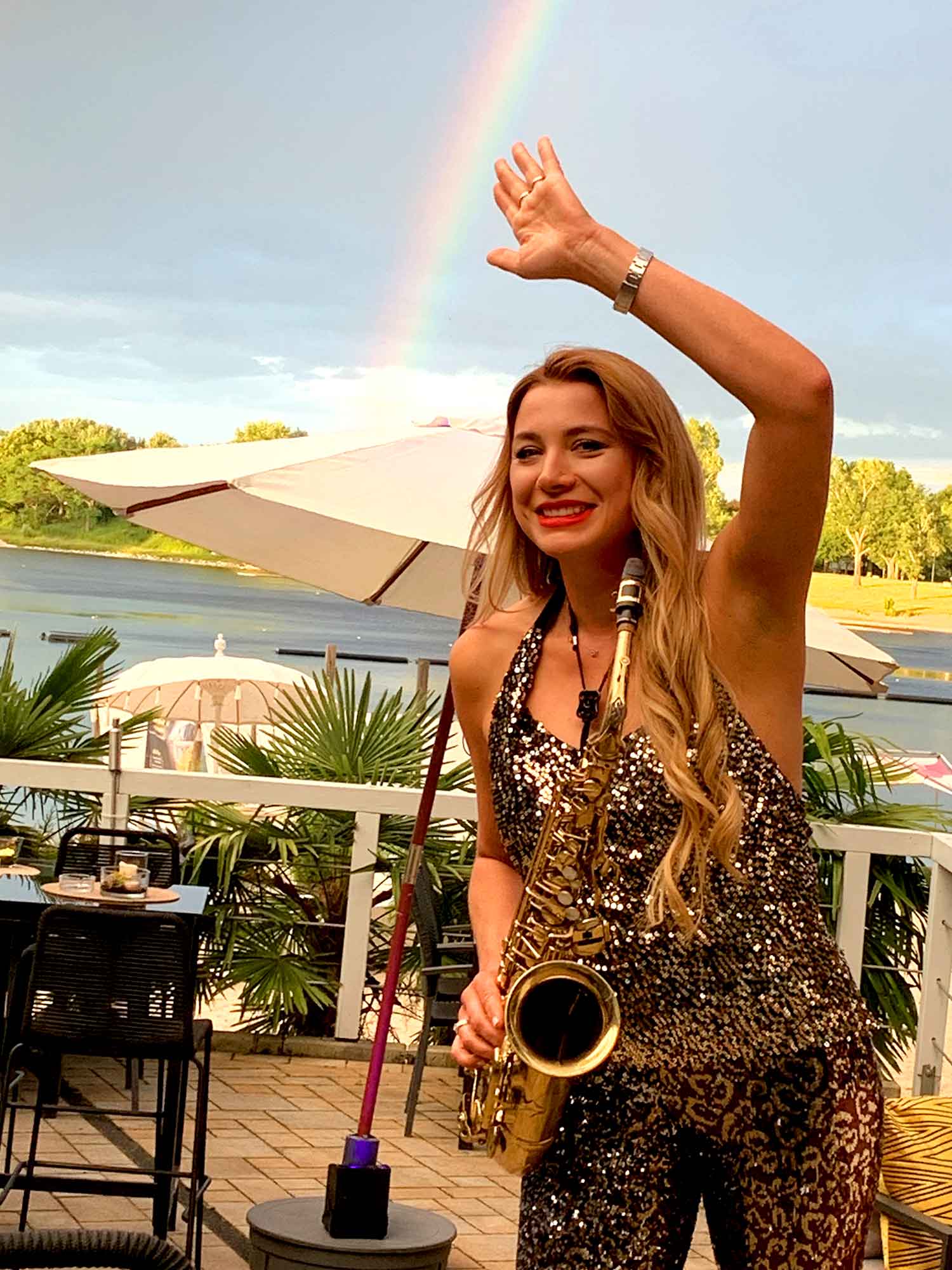 Saxophonist Natalie Marchenko waving to guests at the TIRE Cologne trade fair party in Cologne