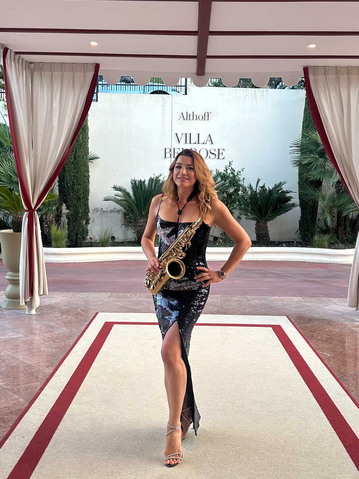 Saxophonist Natalie Marchenko in front of the Althoff Villa Belrose in Saint-Tropez at an exclusive networking event on the Côte d'Azur