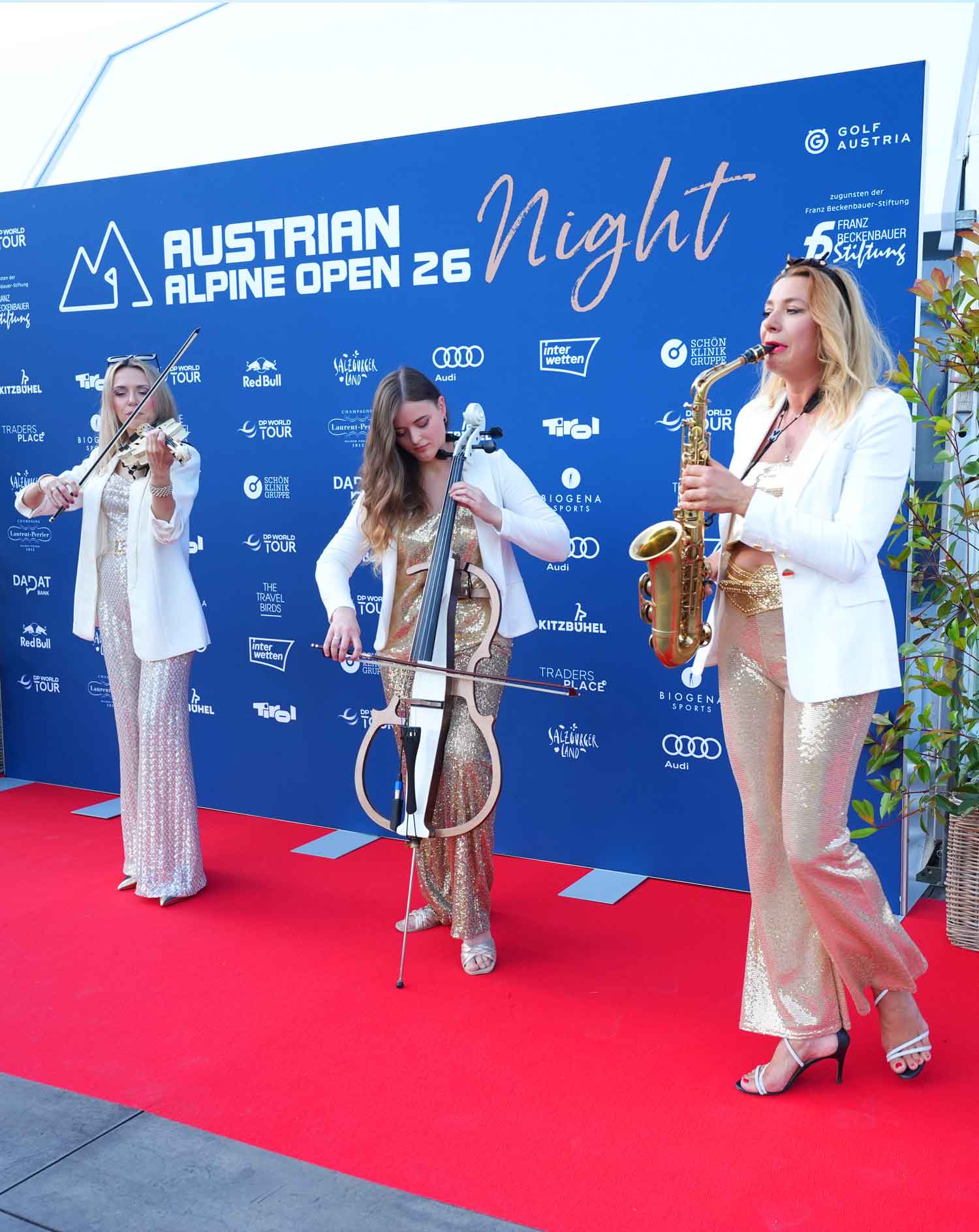 Walking band of saxophonist, violinist and cellist at the Austrian Alpine Open in Kitzbühel, Tyrol